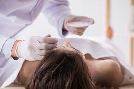 Forensic Pathologist Reviews Autopsy Of Patient With Chest Abscess