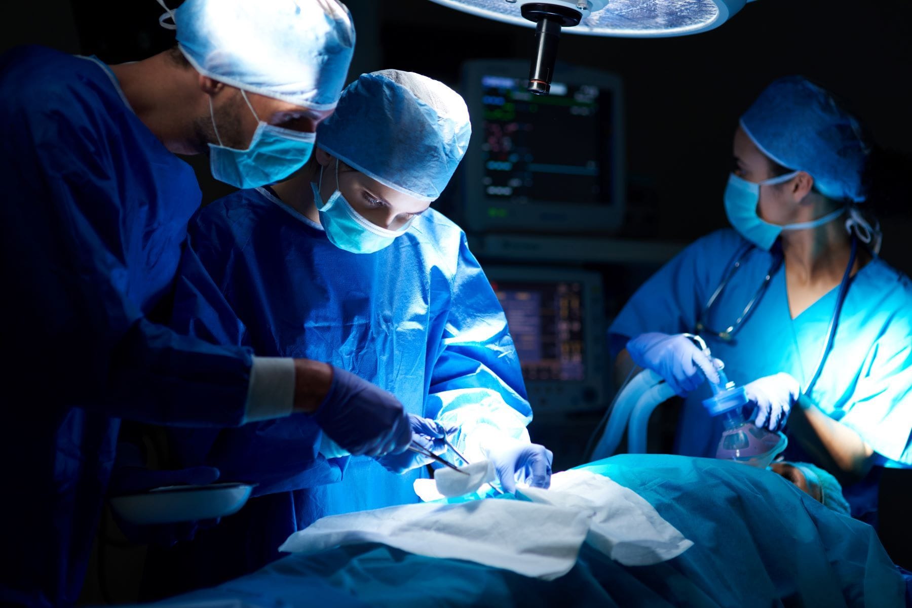 Surgeons operating on patient