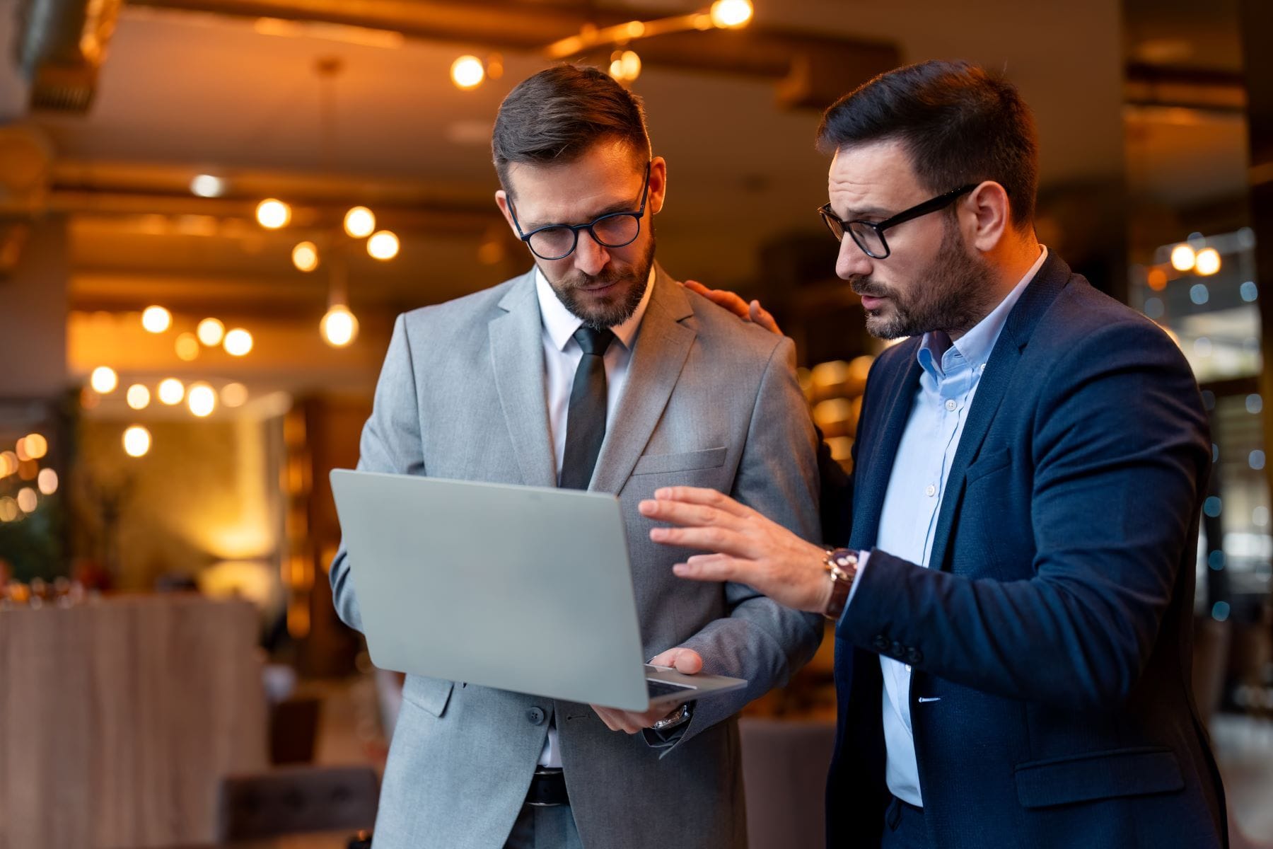 Two attorneys searching for expert witnesses on computer
