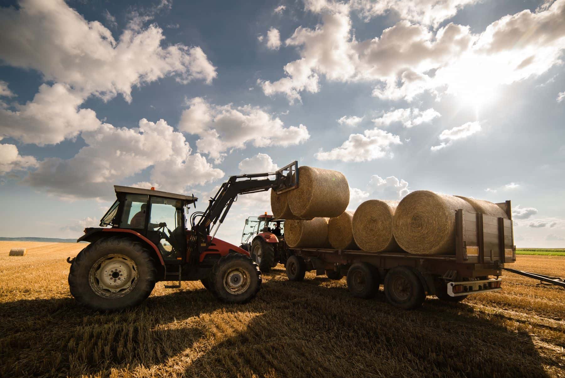 Loading bales of hay onto trailer