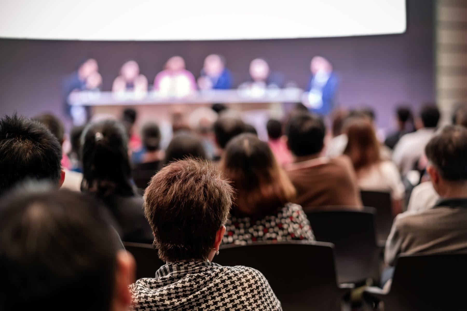Professionals sitting at a conference event