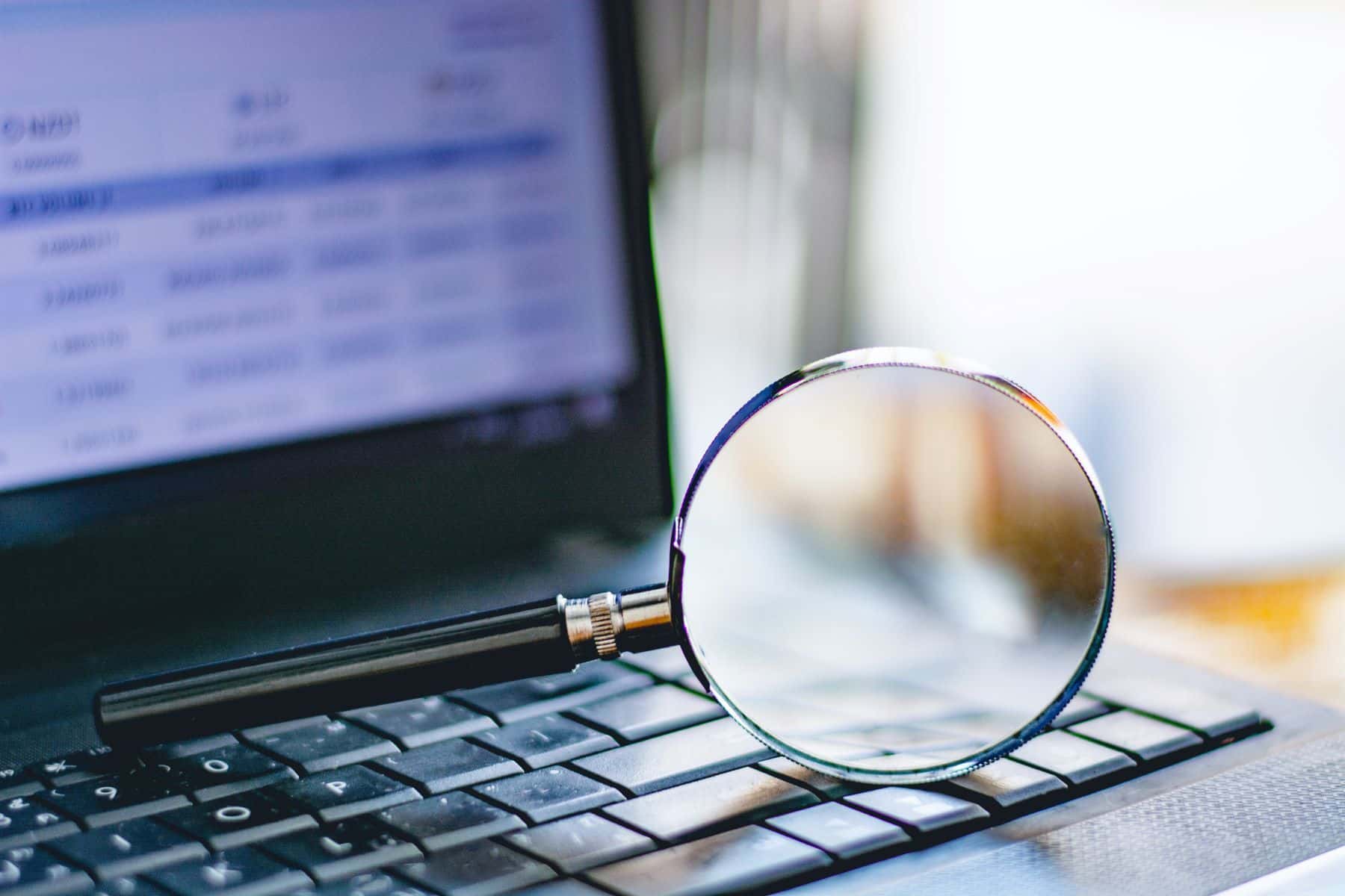 Magnifying glass on laptop computer