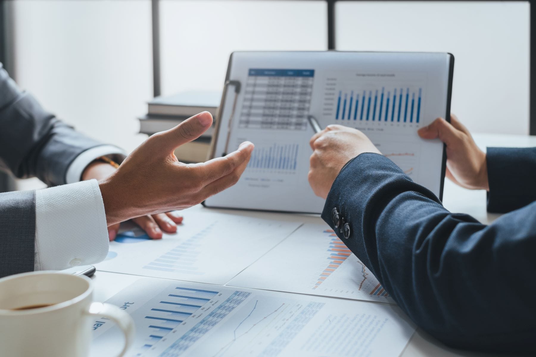 Two professionals reviewing financial charts