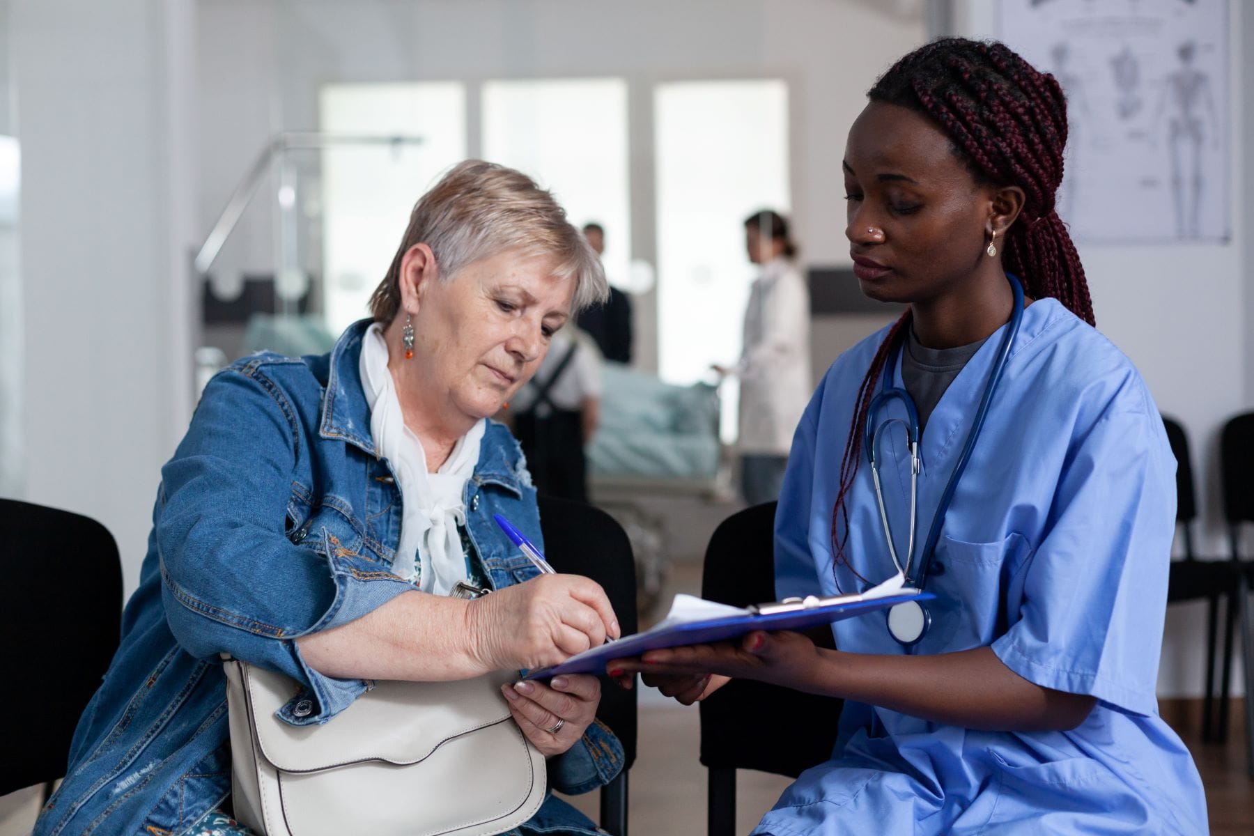 Woman signing discharge documents at hospital