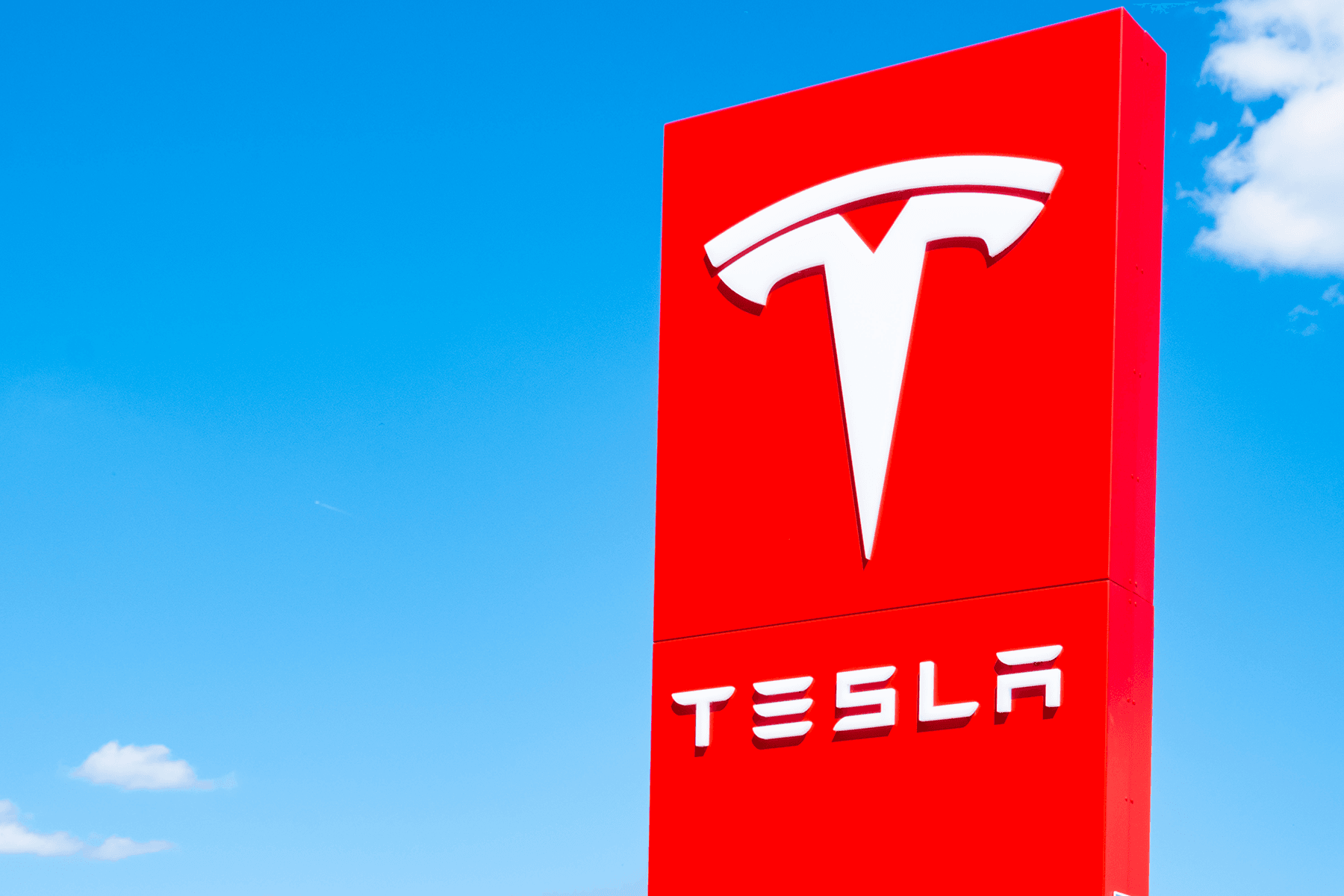 Red Tesla company banner with logo on display