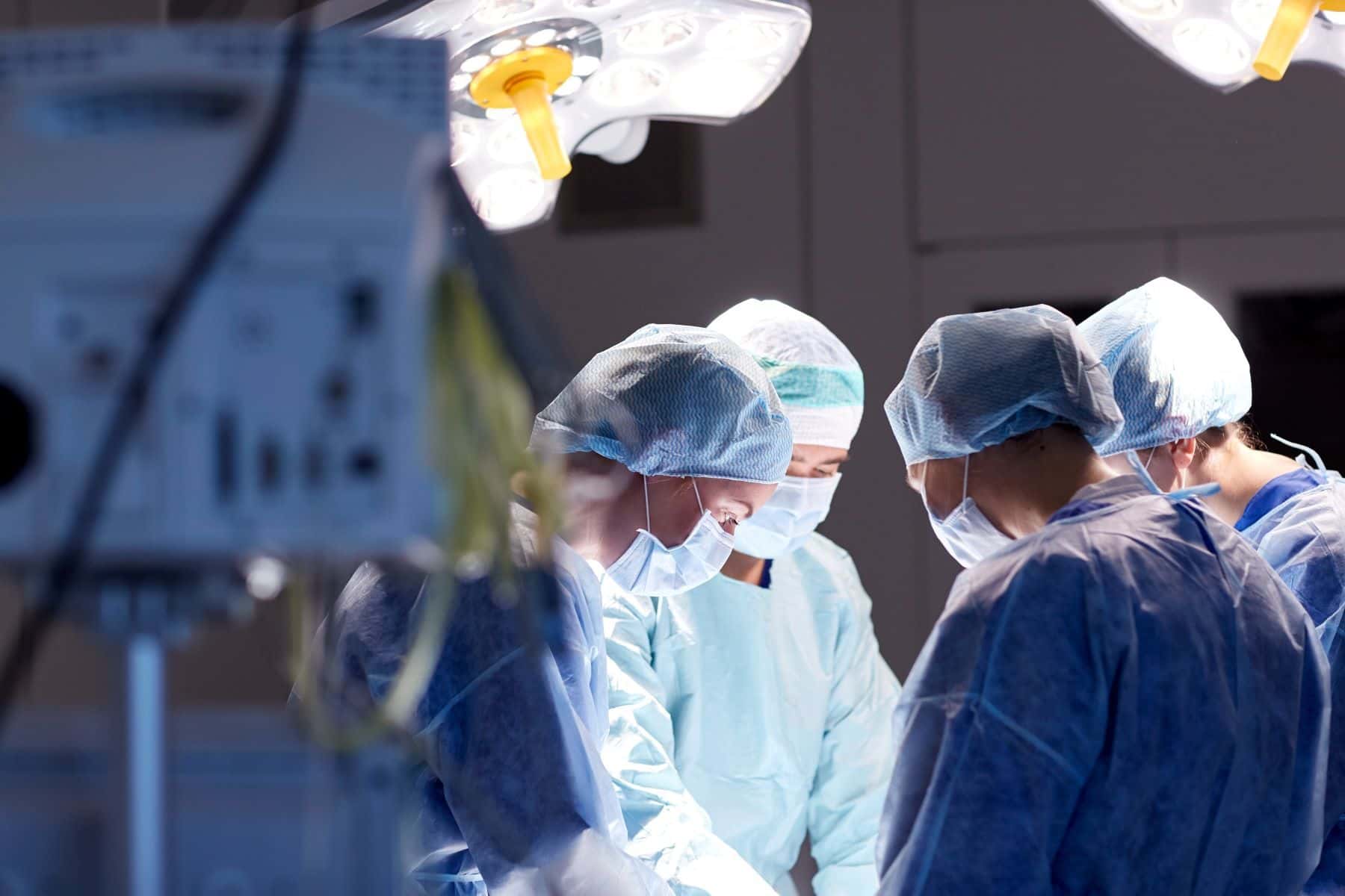 Surgeons operating on patient