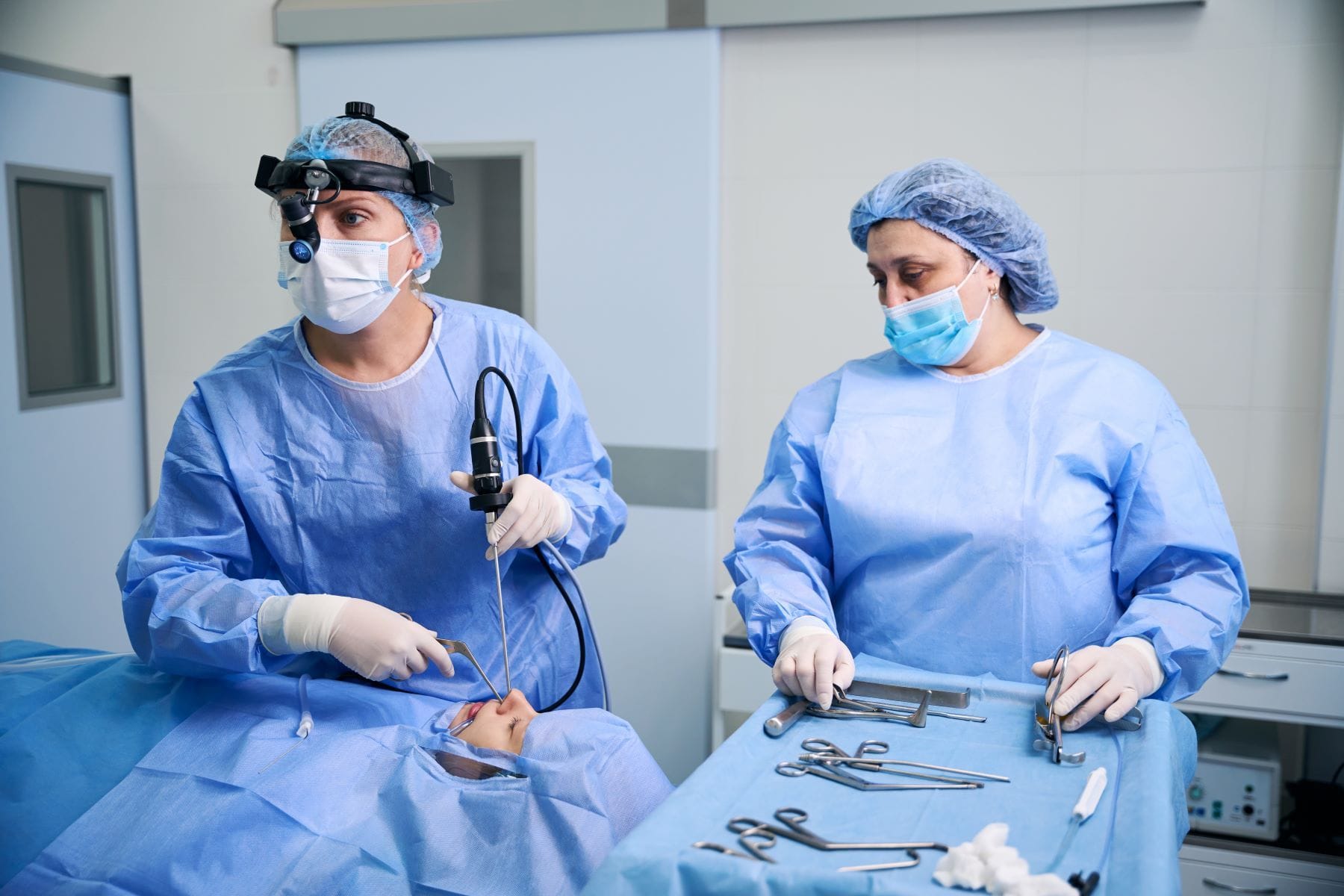 Surgeons performing tonsillectomy