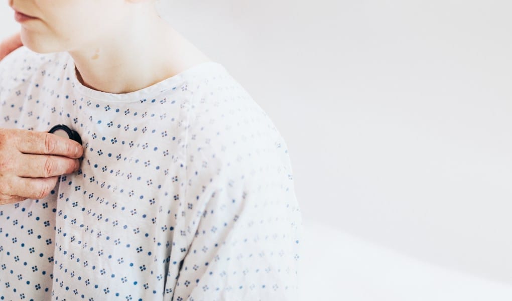 doctor using stethoscope on patient's chest