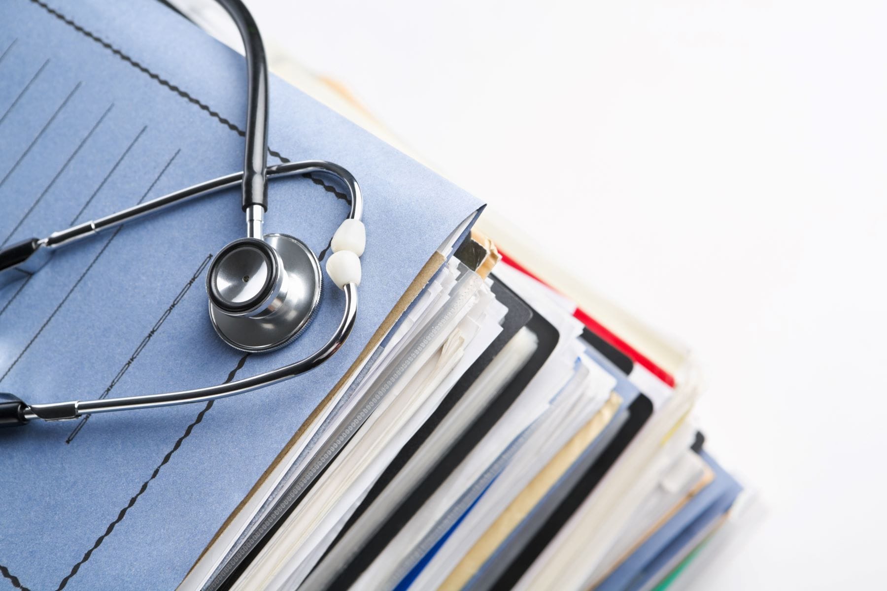 Stethoscope resting on medical files