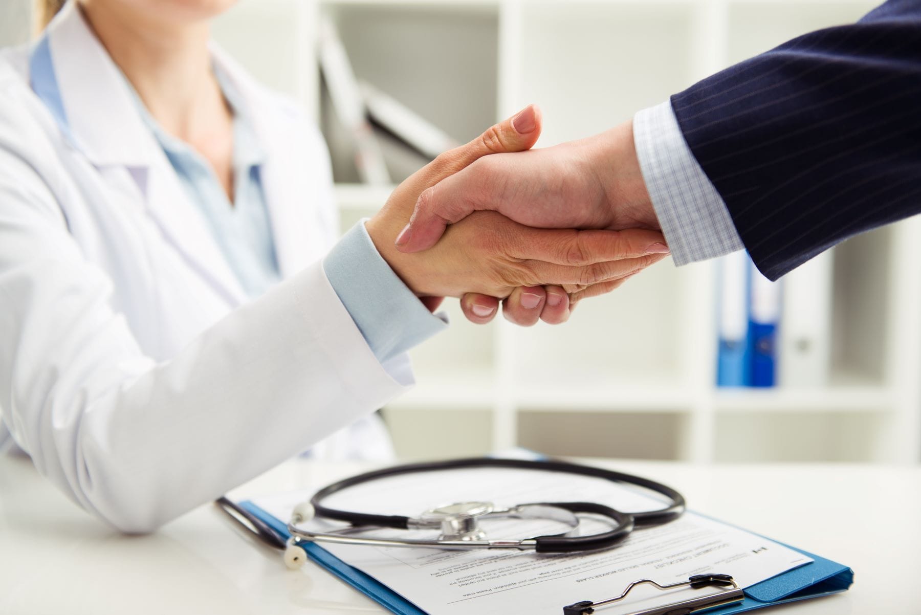 Doctor shaking hands with businessman