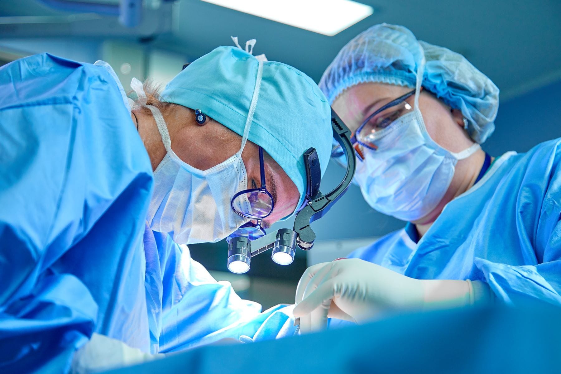 Surgeons operating on patient
